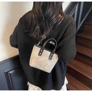 Detailed back view of a vintage small tote bag with black trim and gold hardware accents