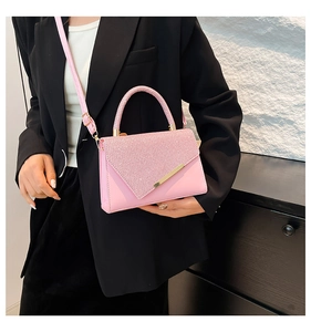 Detail of pink small square bag featuring glitter patchwork and golden metal bar trim