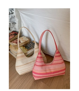 Close-up of woven straw tote bags with colorful stripes and secure zipper closure