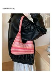Side view of large woven hobo bag with pink and orange gradient stripes on shoulder