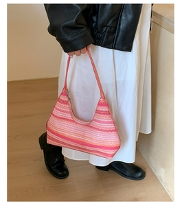 Detail of pink gradient woven hobo bag with textured pattern and shoulder strap