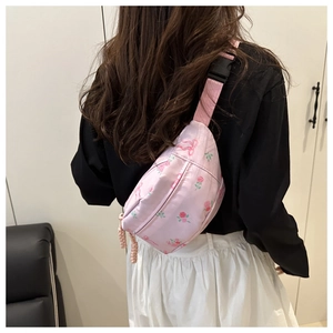 Detailed back view of pink floral dumpling bag with adjustable strap and buckle