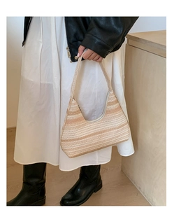 Detail of hand-held beige striped woven hobo shoulder bag for minimalist daily commute