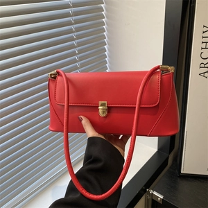 Modern red matte leather baguette shoulder bag with gold rectangular buckle and slim strap