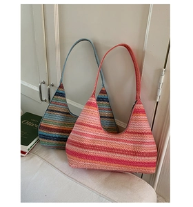 Macro detail of hand-woven striped hobo bag with zip closure and metal feet
