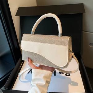 Chic two-tone handbag with asymmetric curved flap and leather strap in creamy white finish