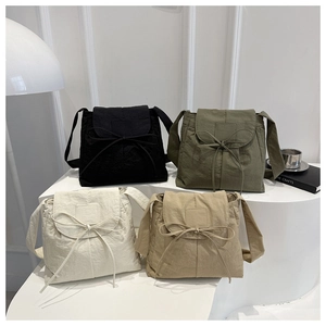 Detailed display of ballet-style nylon crossbody bags in black, olive, white, and khaki