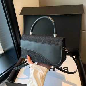 Sparkling black glitter saddle bag with handle and strap in a luxury gift box