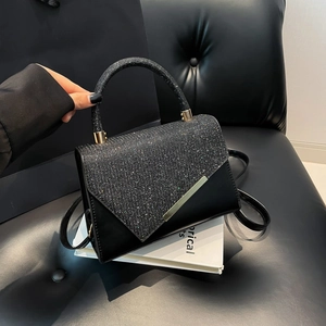 Elegant black sequin handbag with gold metal bar trim and detachable shoulder strap