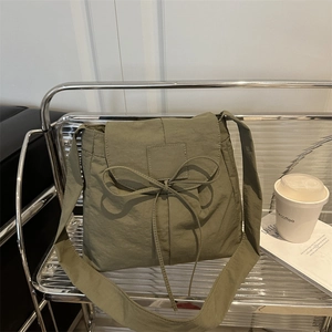 Army green nylon crossbody tote bag with bow detail and wide shoulder strap