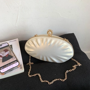 Elegant white shell evening clutch with pearl texture and gold chain strap for weddings