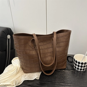 Large dark brown tote bag with crocodile texture and long shoulder straps for daily commute