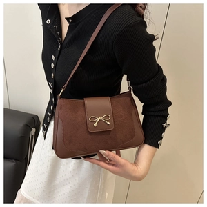 Retro brown leather shoulder bag featuring a gold metal bow clasp and material stitching