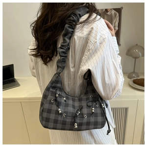 Detail of checkered shoulder bag with pleated scrunchie strap and bead drawstring