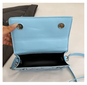 Dettaglio della borsa azzurra con stampa ciliegie con chiusure magnetiche e interno nero