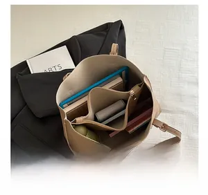 Top view showing large capacity and internal compartments of beige tote bag