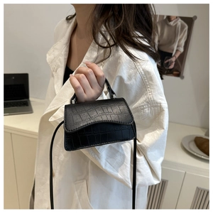 Detail of black crocodile texture on a vintage mini square crossbody bag for women