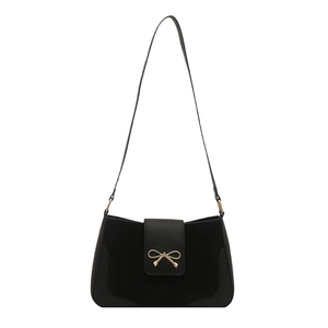 Minimalist black crossbody shoulder bag with matte texture and golden bow buckle detail
