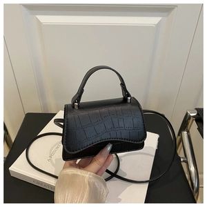 Detail of black crocodile pattern leather mini square bag with silver metal buckle