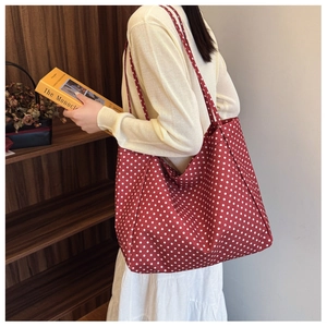 Detail of red polka dot canvas tote bag showing large capacity and soft fabric texture