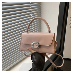 Detail of pink small square bag featuring a crystal-encrusted G-shaped silver buckle