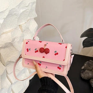 Pink PU leather handbag featuring cute red cherry prints and 3D crystal cherry embellishment