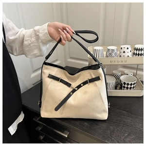 Detail of a large two-tone tote bag with suede texture and black leather strap accents