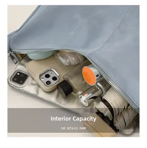 Top view of open light blue faux leather tote bag showing spacious internal capacity