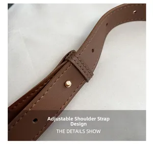 Detail of adjustable dark brown leather strap with gold rivet and precision stitching