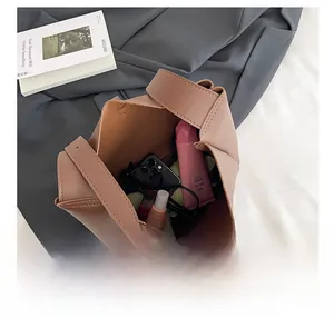 Top view of large mocha leather bucket bag showing spacious interior with daily essentials