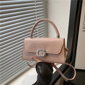 Pink faux leather square handbag with diamond-encrusted G buckle and top handle
