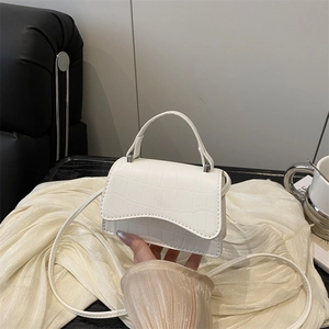 White crocodile pattern crossbody bag with top handle and sleek rectangular design