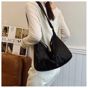 Close-up of a black oversized nylon hobo bag worn over the shoulder for a chic commute