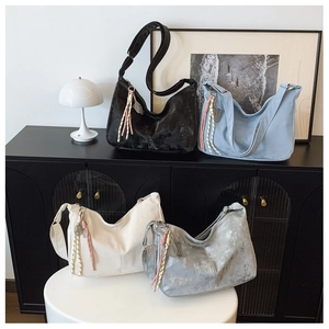 Collection of minimalist large nylon hobo bags in four colors with braided tassels