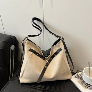 Vintage beige suede tote bag with black leather trim and metal buckles for women