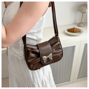 Brown pleated cloud bag featuring silver bow buckle and smooth shoulder strap details