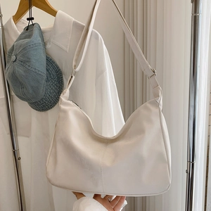 Minimalist cream white crescent hobo bag with adjustable strap and silver zipper closure