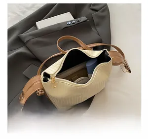 Interior view of off-white gathered handbag showing capacity for wallet and cosmetics