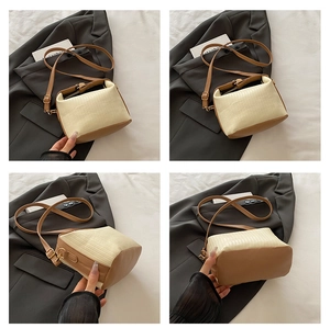 Detail view of cream woven texture handbag with brown leather base and adjustable strap