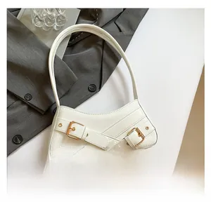 Top view of white faux crocodile leather underarm bag with gold metal buckle accents