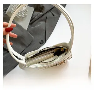 Top view of white hobo bag interior showing spacious capacity for phone and makeup