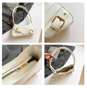 Detail shots of white crocodile embossed underarm bag with gold buckles and zipper