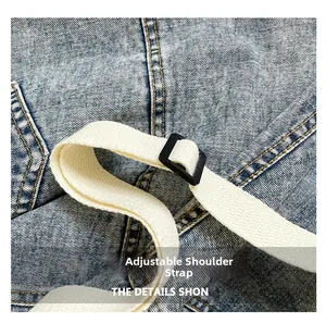 Close-up of the blue corduroy bag showing adjustable strap and black plastic buckle