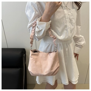 Detail of light pink tote bag featuring a cute bear print and ruffled shoulder strap