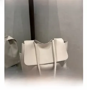 Close-up of cream soft leather tote bag with flap closure and dual shoulder straps