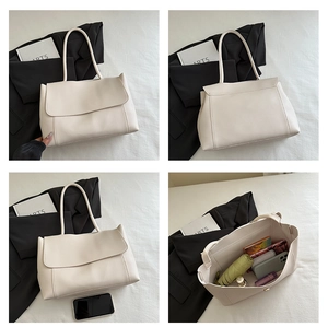 Detail view of cream tote bag with large capacity for umbrella and phone storage