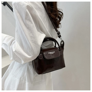 Petit sac carré en cuir verni marron foncé avec lettrage blanc et bandoulière réglable