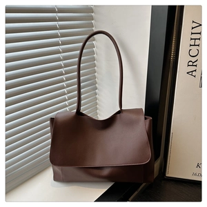 Minimalist dark brown tote bag on windowsill with cinematic shutter light and shadow