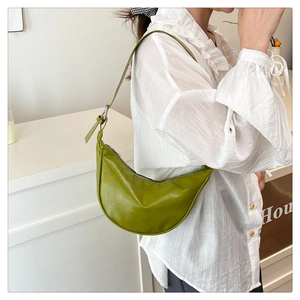 Green leather half-moon shoulder bag with adjustable strap and silver metal ring hardware
