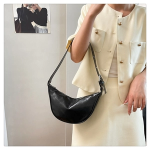 Black hobo shoulder bag in smooth synthetic leather with adjustable strap on model
